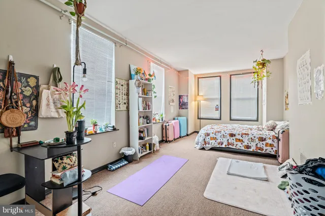 a bedroom with bed and a window