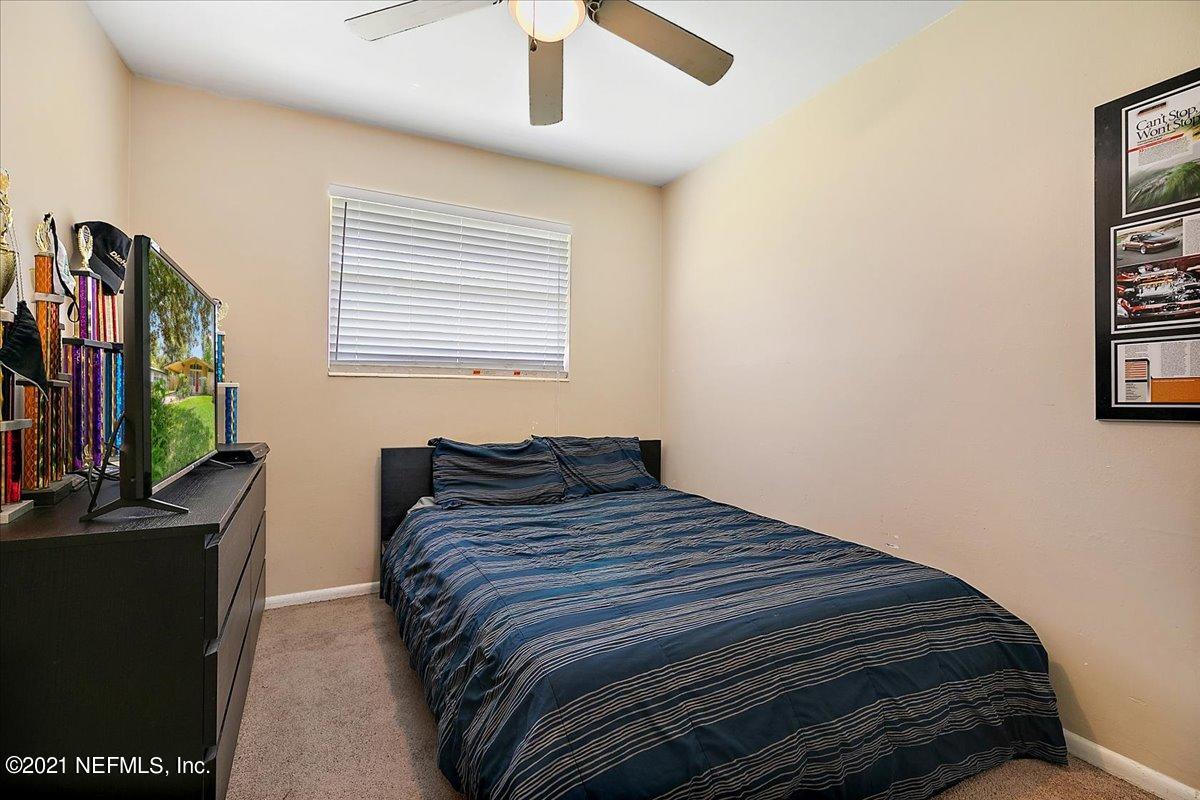 7444 Sandhurst Road South Jacksonville, FL 32277 - Photo 12 of 20 a bedroom with a bed and a flat screen tv