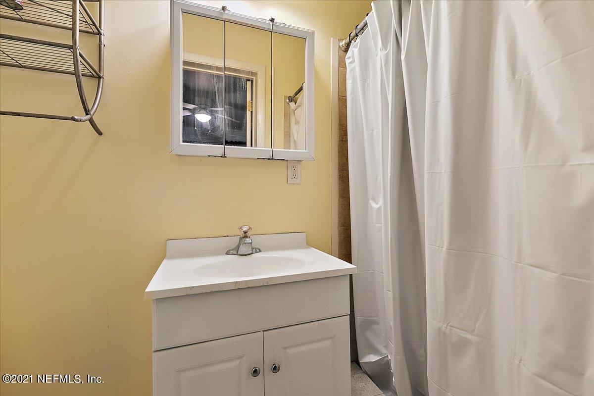 7444 Sandhurst Road South Jacksonville, FL 32277 - Photo 13 of 20 a bathroom with a sink and a mirror