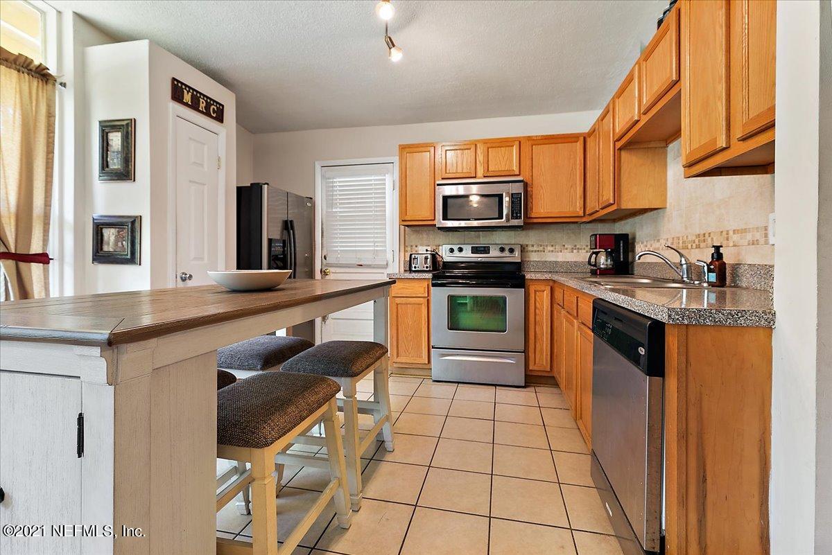 7444 Sandhurst Road South Jacksonville, FL 32277 - Photo 2 of 20 a kitchen with stainless steel appliances granite countertop a stove a sink and a microwave