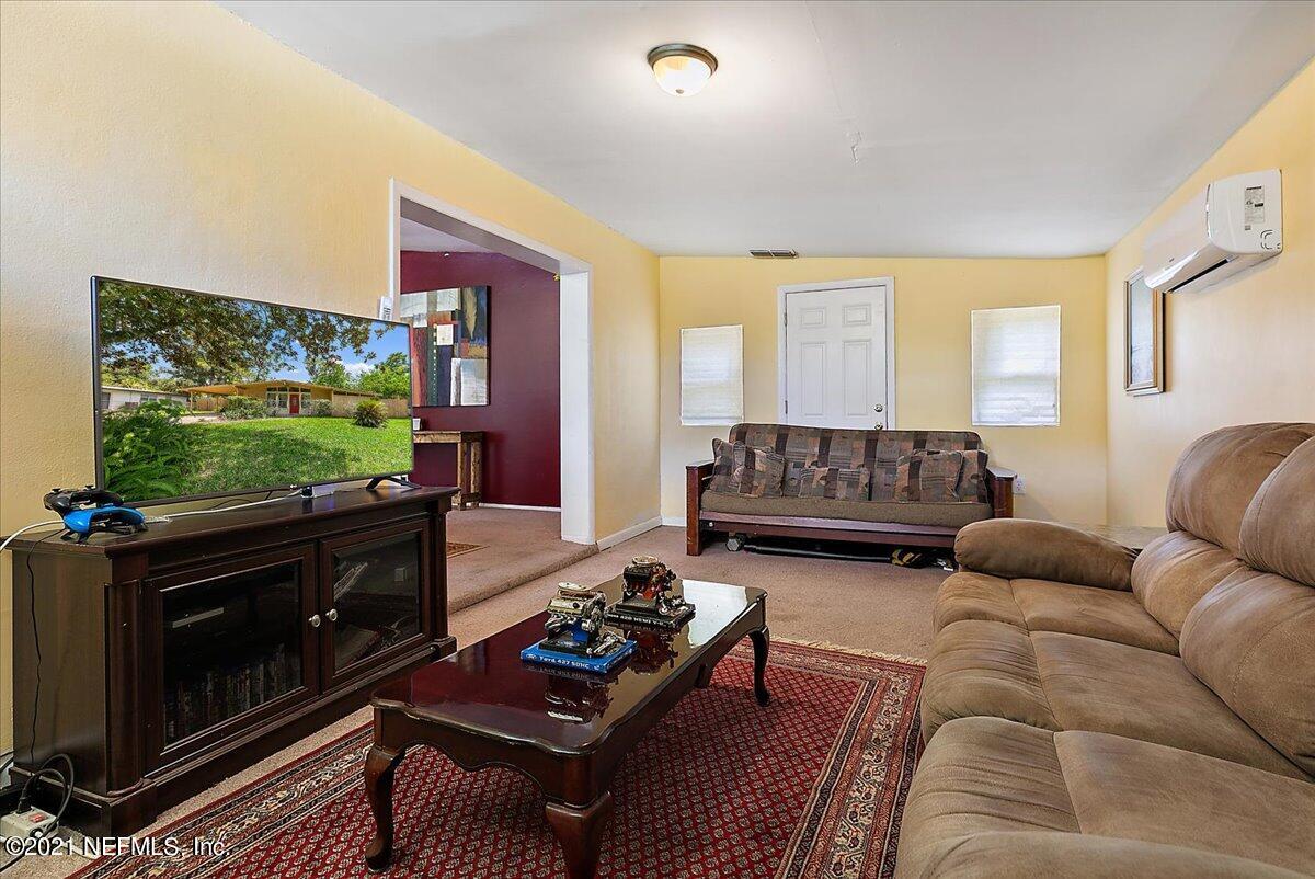 7444 Sandhurst Road South Jacksonville, FL 32277 - Photo 3 of 20 a living room with furniture flat screen tv and wooden floor