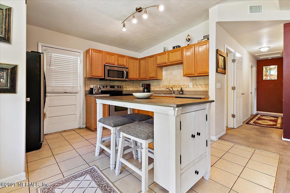 7444 Sandhurst Road South Jacksonville, FL 32277 - Photo 9 of 20 a kitchen with stainless steel appliances a stove a sink and a refrigerator