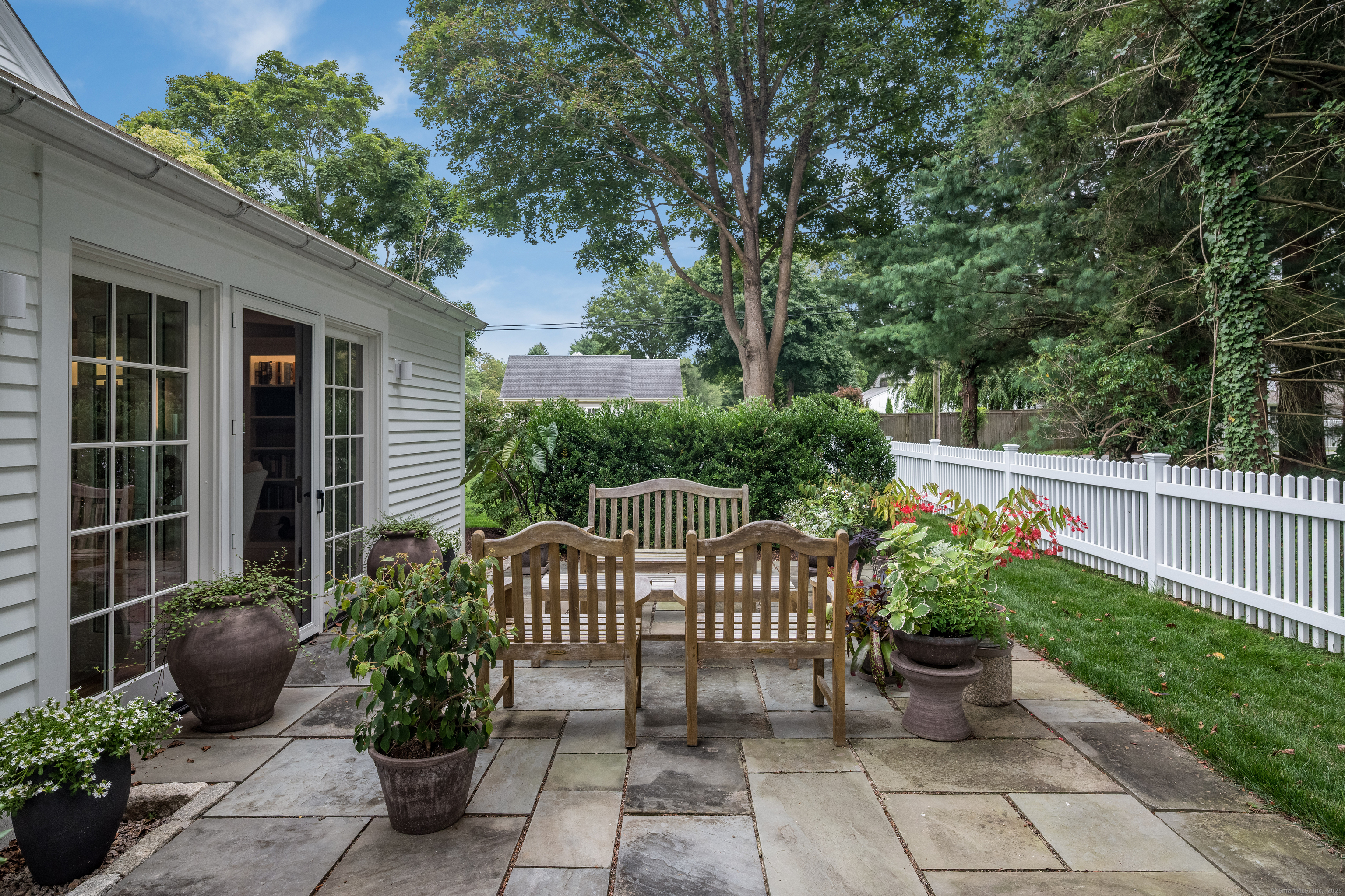 8 Lieutenant River Lane Old Lyme, CT 06371 - Photo 11 of 38 a view of a chair and table and potted on the side of the house