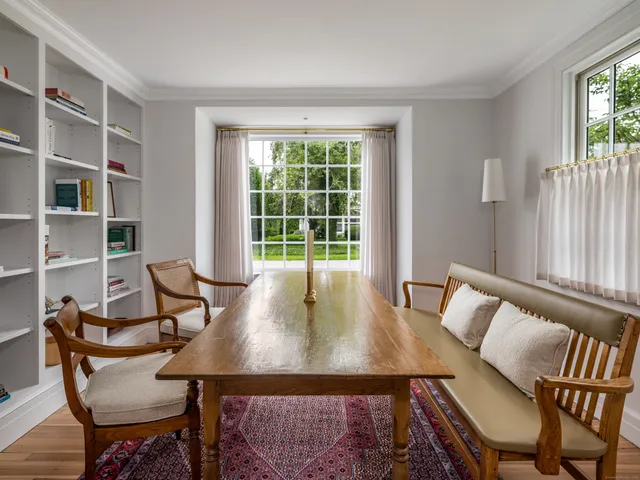 a view of a dining room with furniture and a window