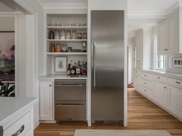 a kitchen with cabinets and a refrigerator