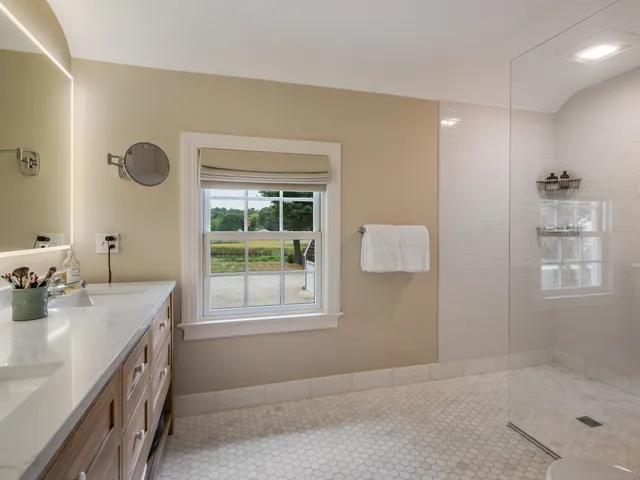 a bathroom with a sink double vanity and a tub