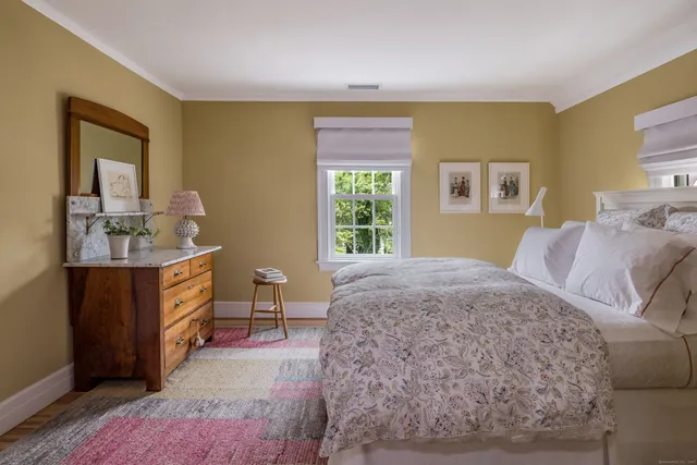 a bed room with a bed and a dresser