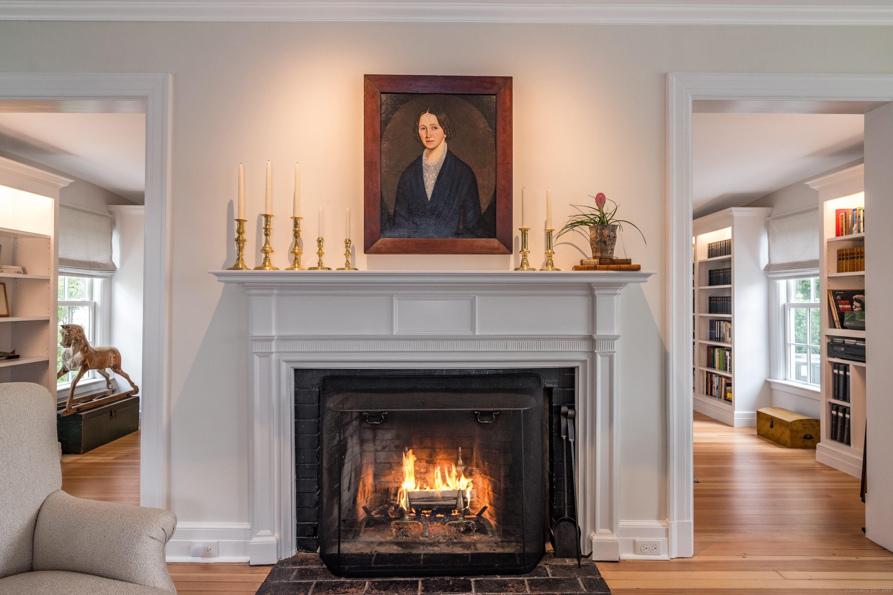 8 Lieutenant River Lane Old Lyme, CT 06371 - Photo 5 of 38 a living room with a fireplace a flat screen tv and a couch