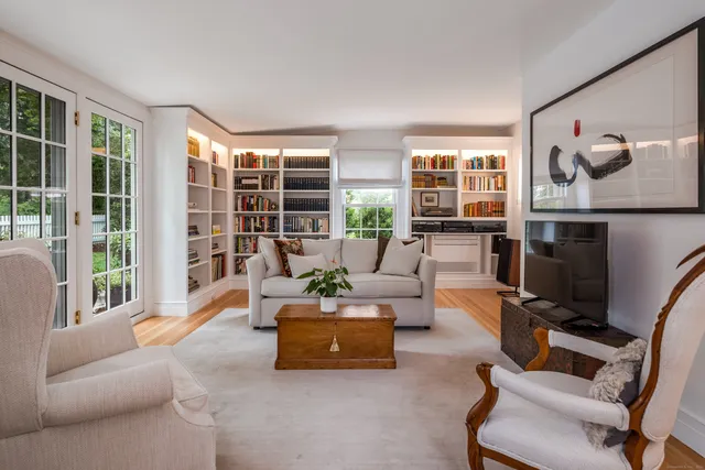 a living room with furniture and a floor to ceiling window
