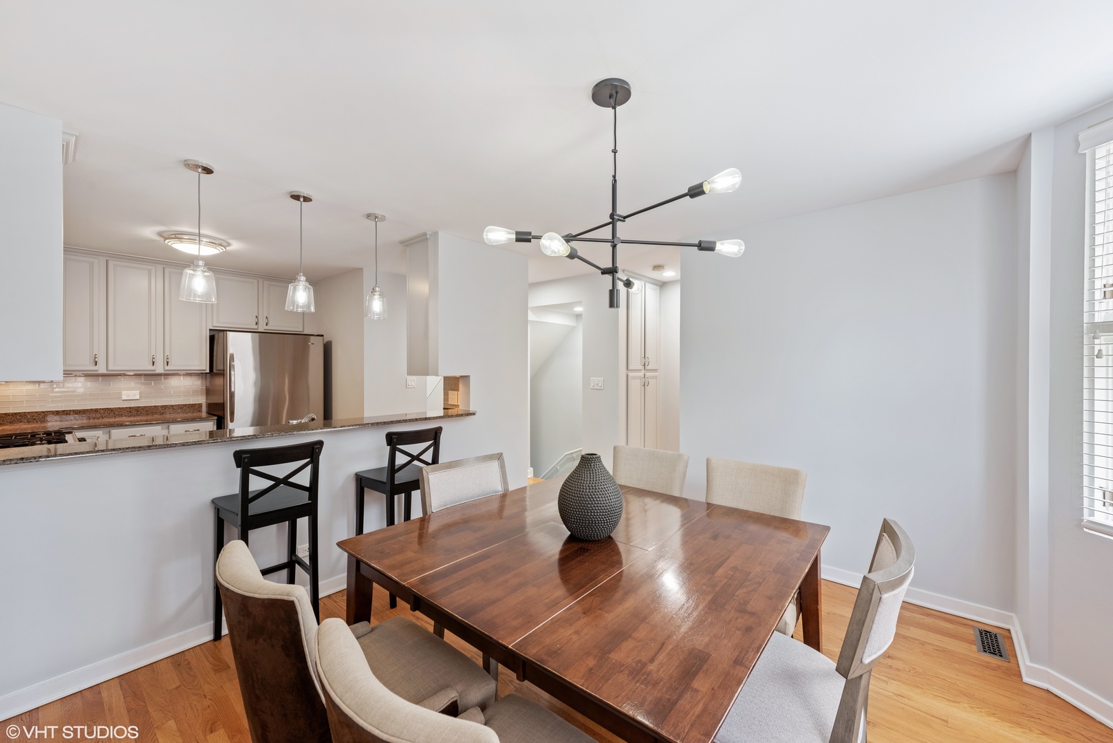 2024 North Racine Avenue, Unit M Chicago, IL 60614 - Photo 8 of 22 a view of a dining room and livingroom with furniture wooden floor a chandelier