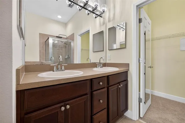 a bathroom with a double vanity sink and a mirror