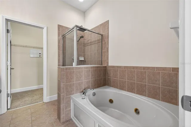 a bathroom with a tub a shower and a sink