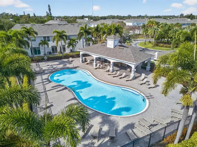 an aerial view of a house with outdoor space and lake view