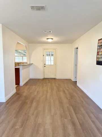 wooden floor in an empty room with a window