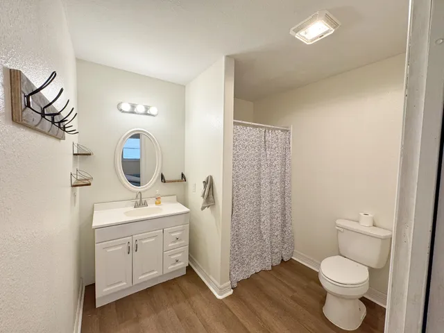 a bathroom with a toilet a sink and a mirror