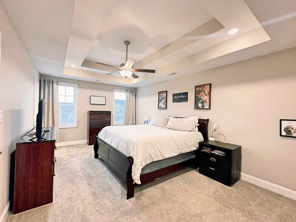 a spacious bedroom with a bed and a dresser