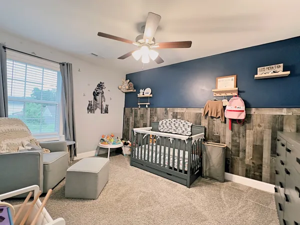 a bedroom with furniture and a window