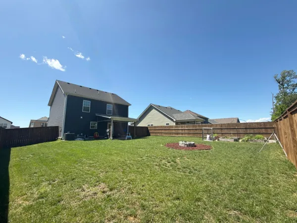 a view of an house with backyard of house