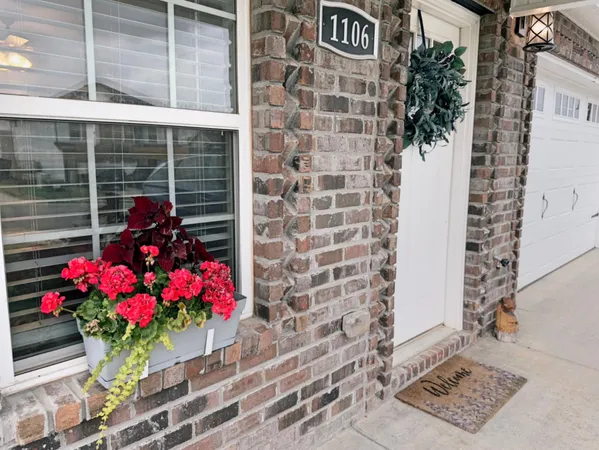 a vase of flowers sitting on a floor