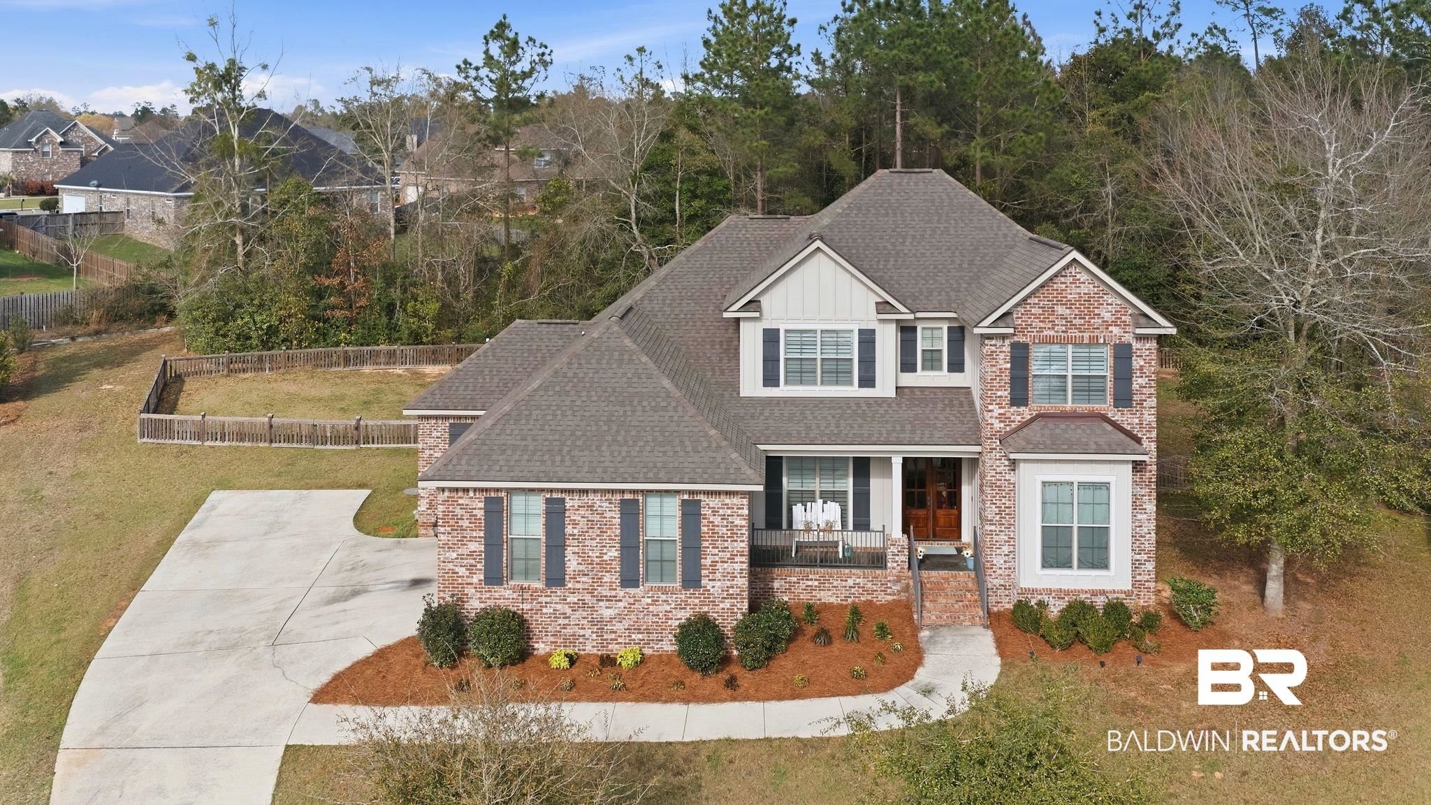 32194 Badger Court Daphne, AL 36527 - Photo 2 of 49 Craftsman house with a shingled roof, a porch, brick siding, a front yard, and board and batten siding