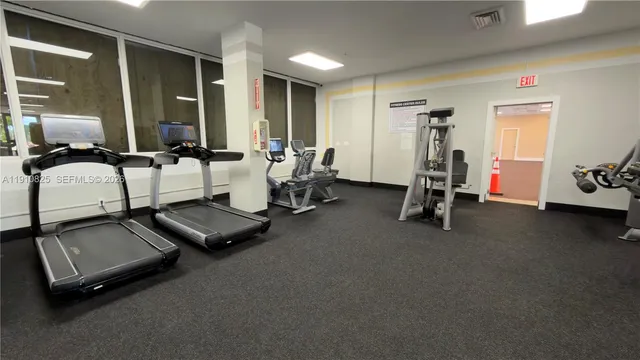 a room with gym equipment and a table