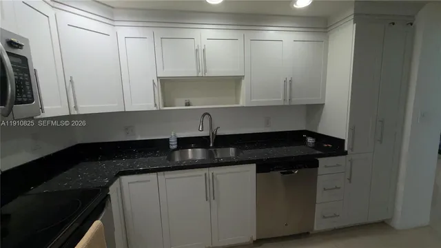 a kitchen with a sink and cabinets