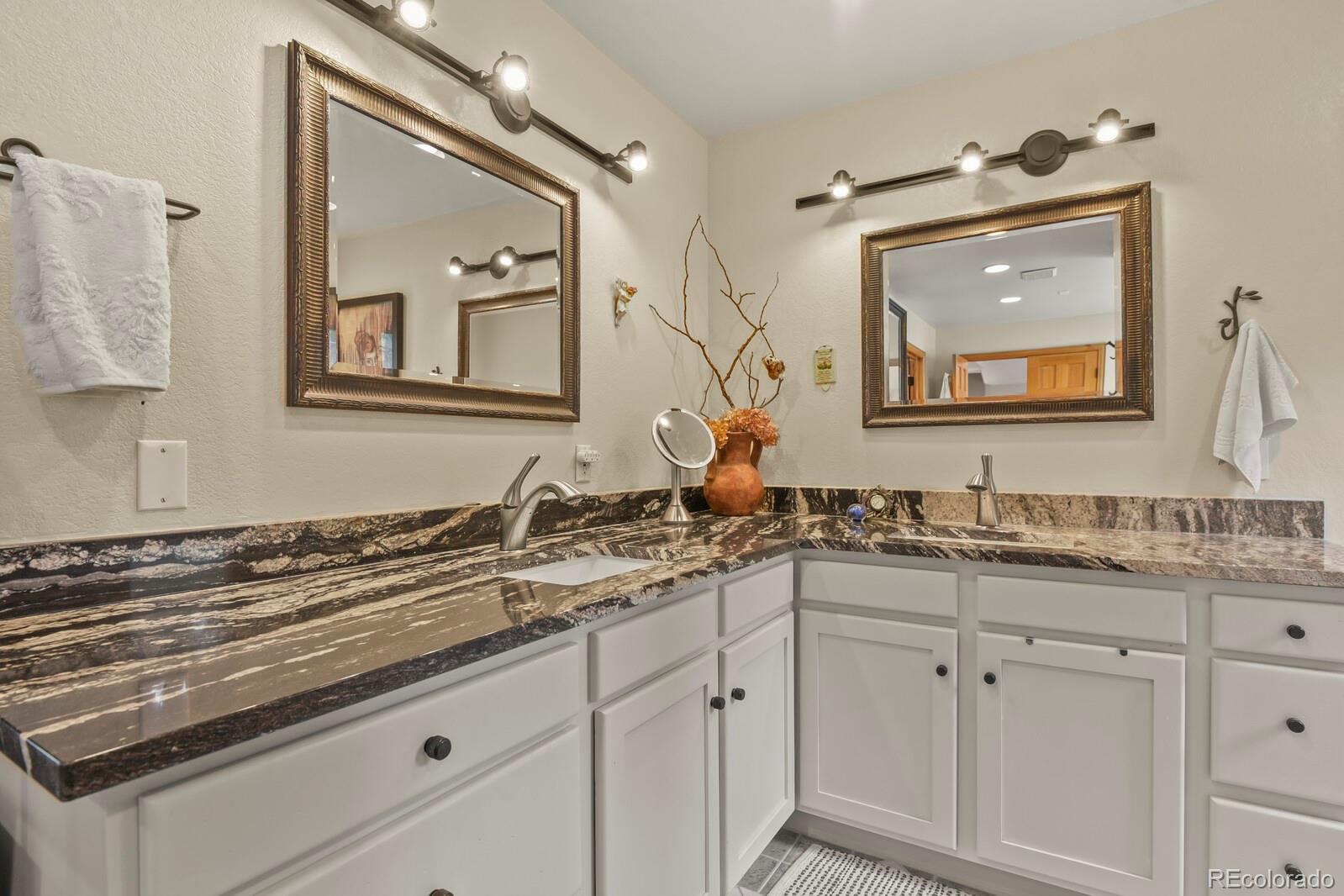 417 Witter Gulch Road Evergreen, CO 80439 - Photo 30 of 50 a bathroom with a granite countertop sink vanity and mirror