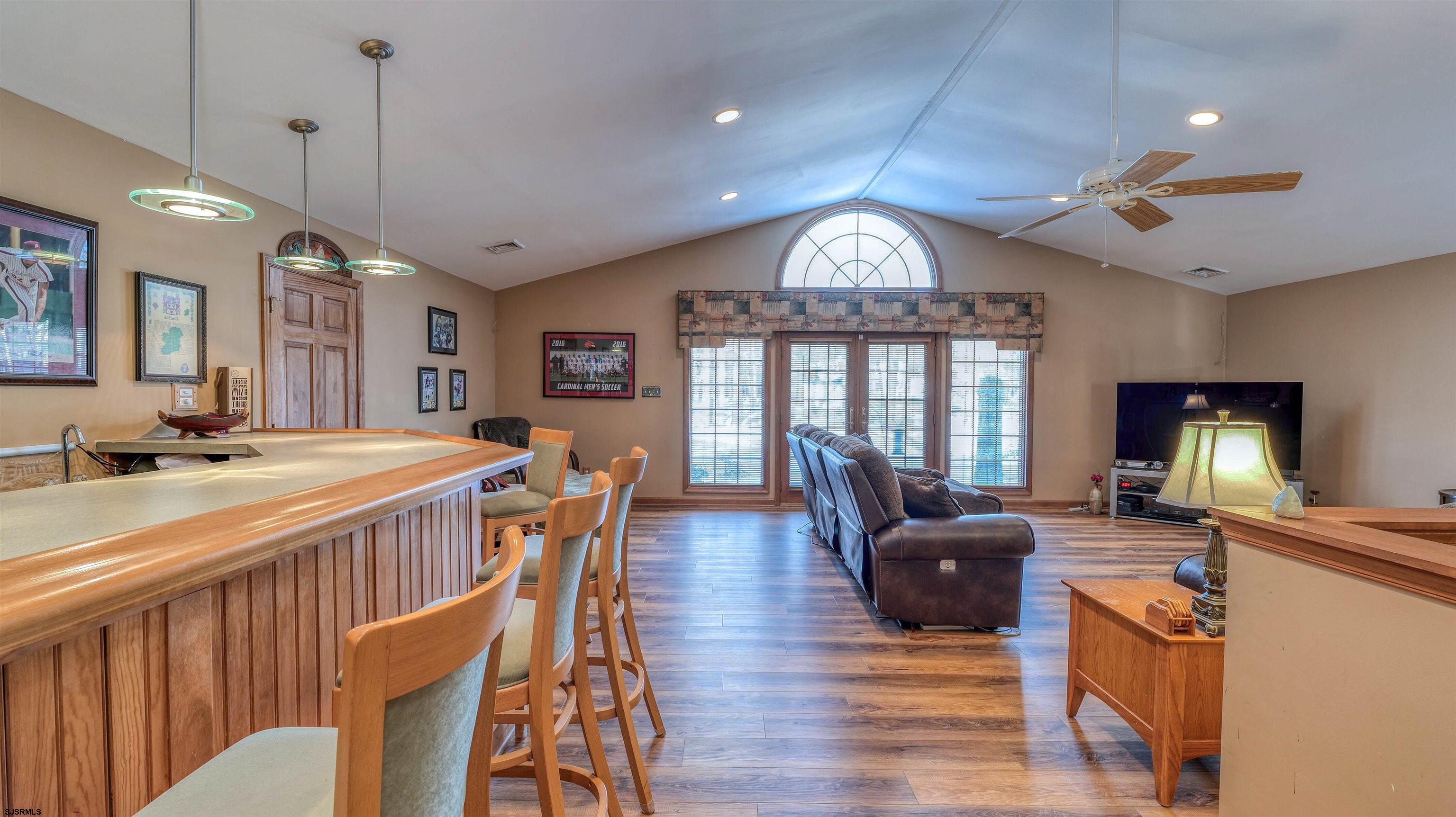 627 East Seaview Ridge Drive Galloway Township, NJ 08205 - Photo 25 of 50 a view of a dining room with furniture a chandelier and wooden floor