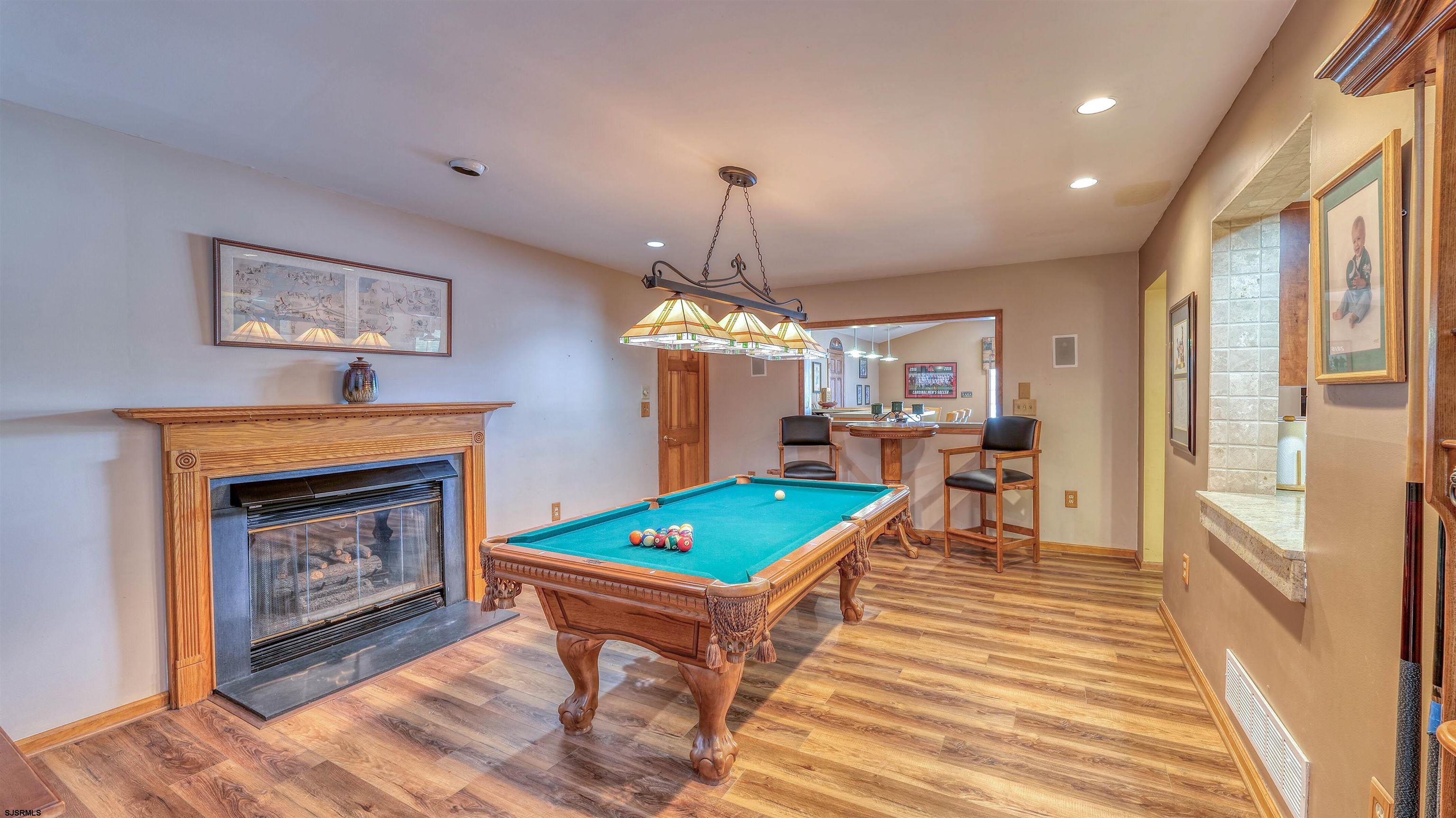 627 East Seaview Ridge Drive Galloway Township, NJ 08205 - Photo 27 of 50 a living room with furniture a fireplace and a chandelier