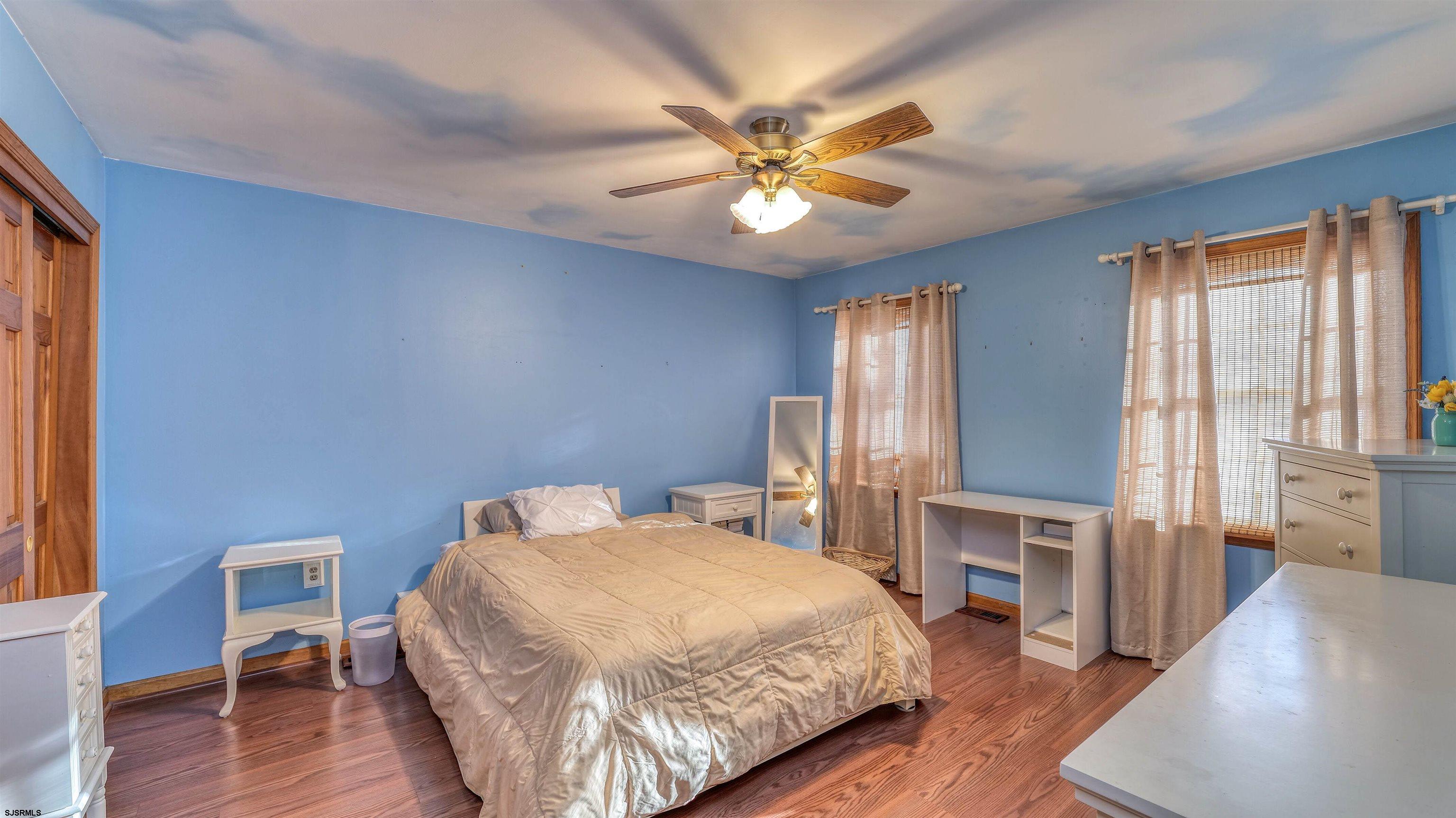 627 East Seaview Ridge Drive Galloway Township, NJ 08205 - Photo 31 of 50 a bedroom with a bed and a chandelier