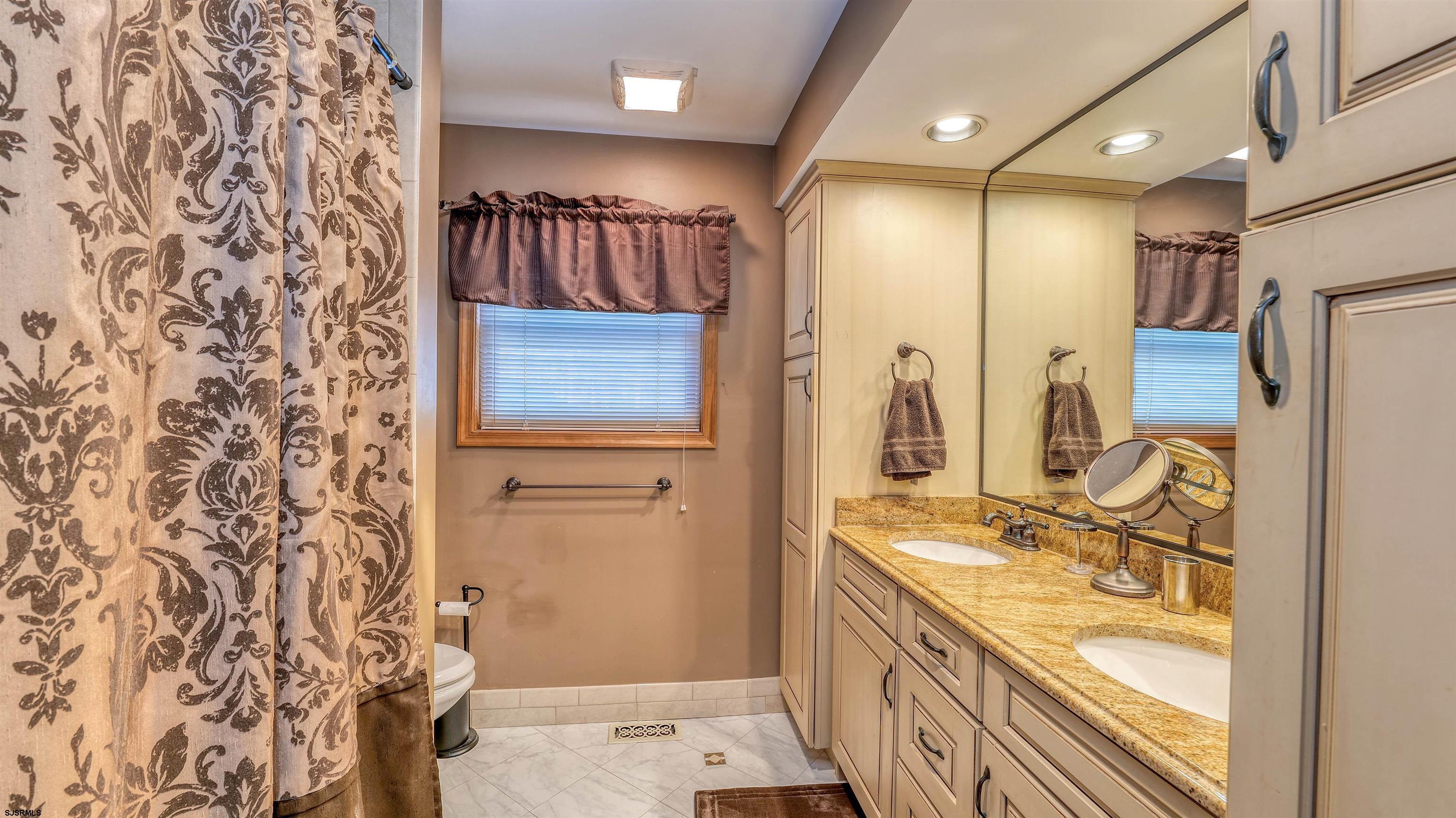 627 East Seaview Ridge Drive Galloway Township, NJ 08205 - Photo 33 of 50 a bathroom with a granite countertop sink a mirror and shower