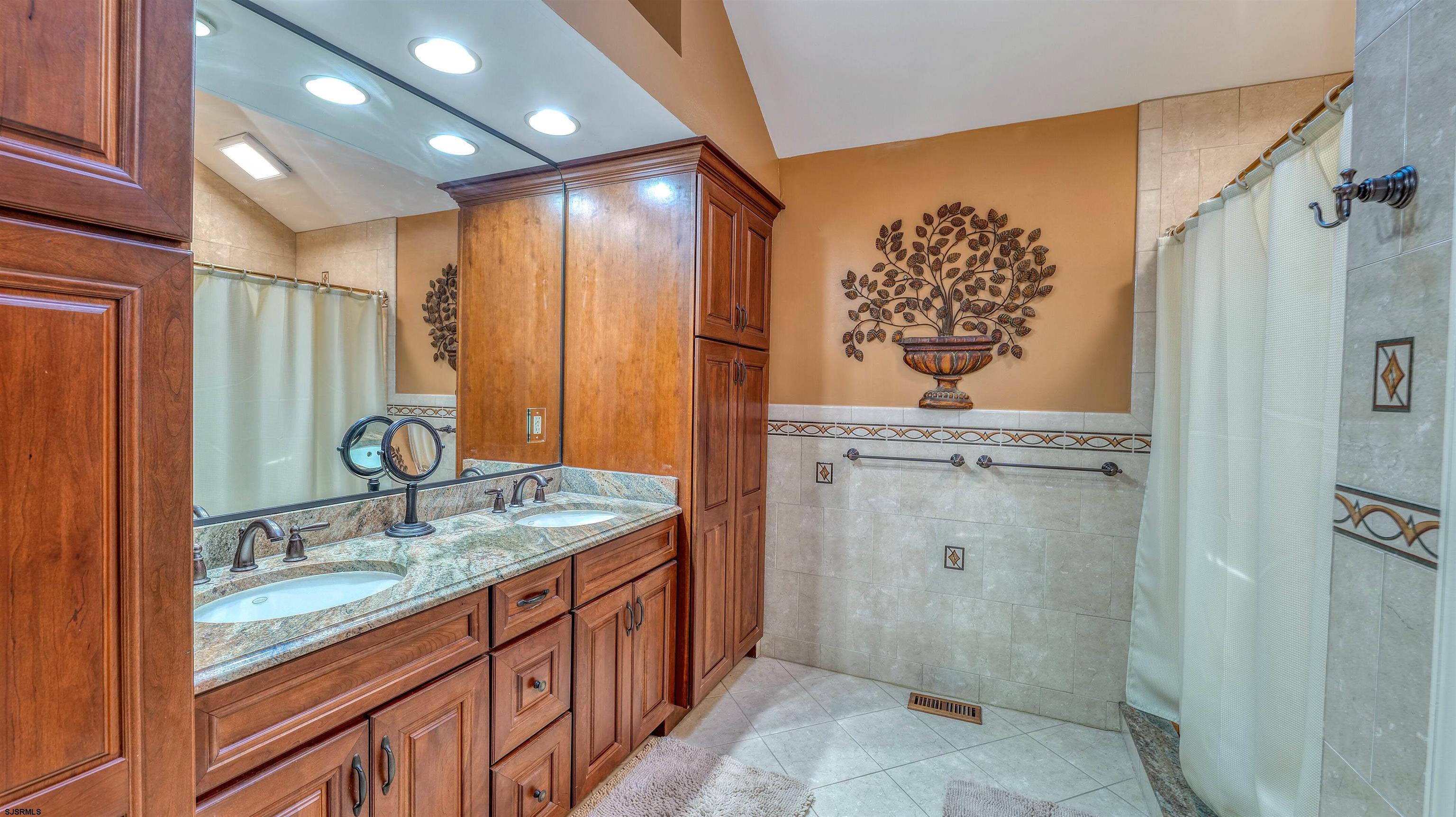 627 East Seaview Ridge Drive Galloway Township, NJ 08205 - Photo 36 of 50 a bathroom with a granite countertop sink a mirror a vanity and shower