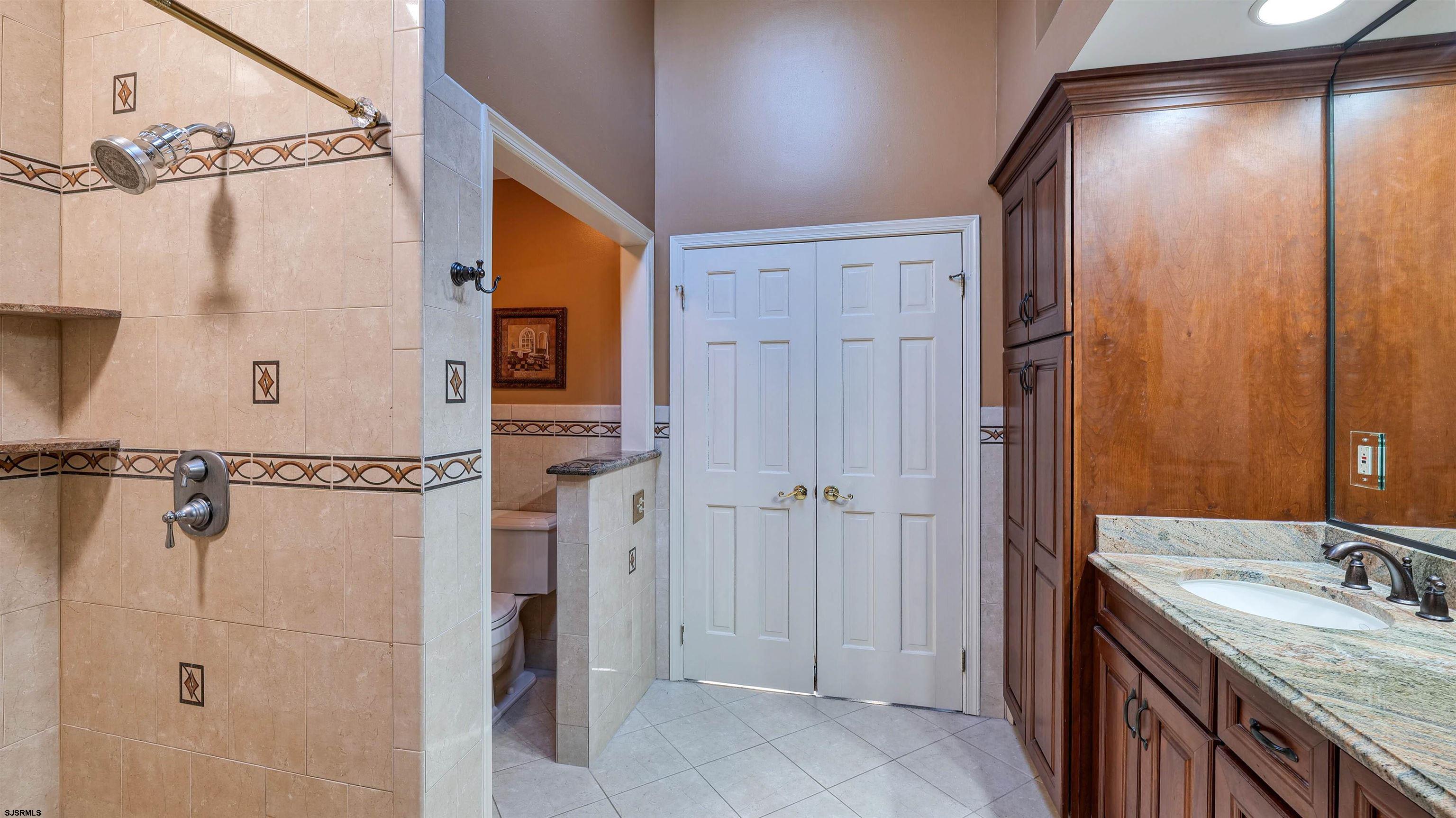 627 East Seaview Ridge Drive Galloway Township, NJ 08205 - Photo 37 of 50 a bathroom with a granite countertop shower sink vanity and mirror