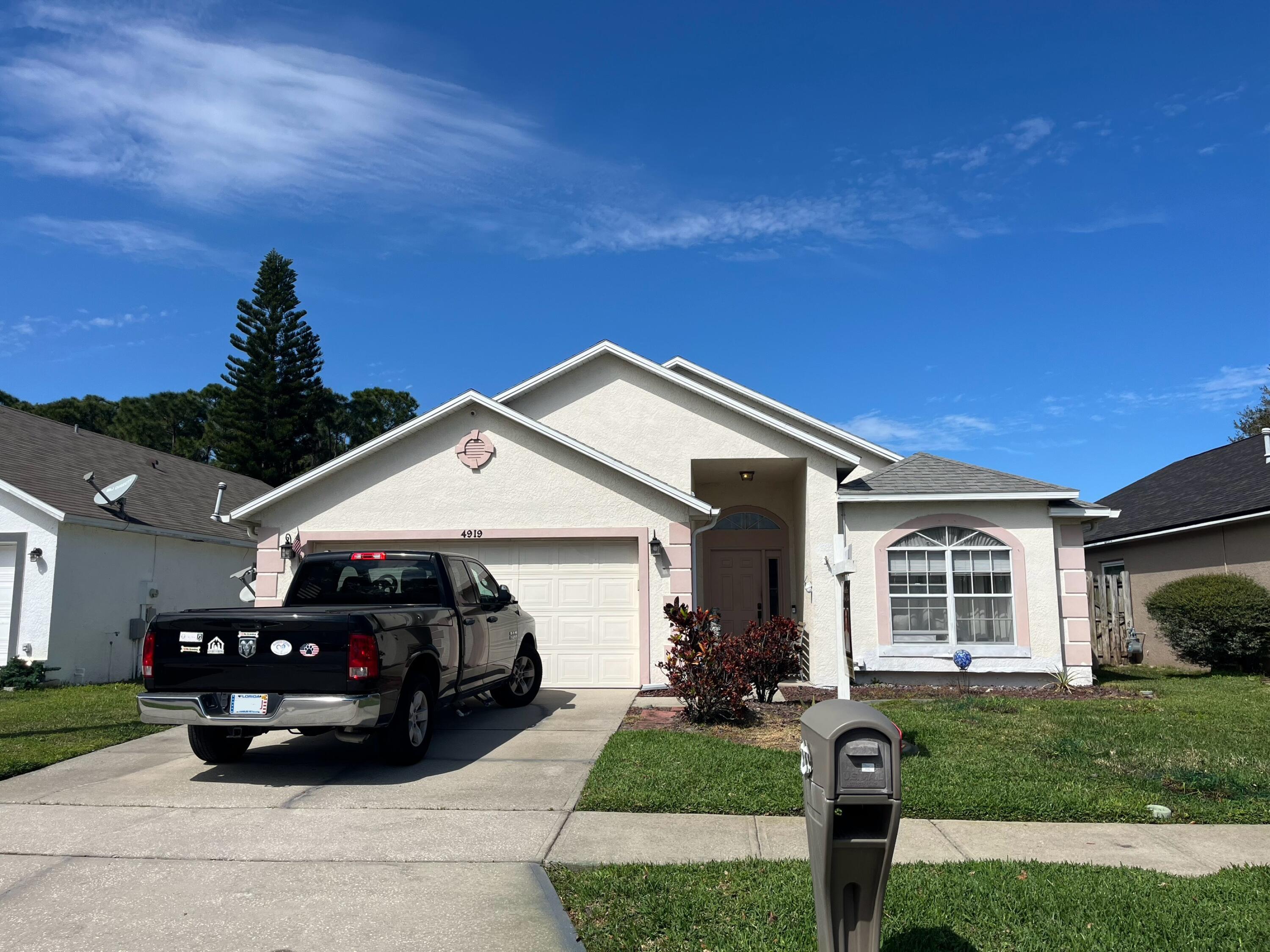 4919 Erin Lane Melbourne, FL 32940 - Photo 1 of 13 a front view of a house with a yard