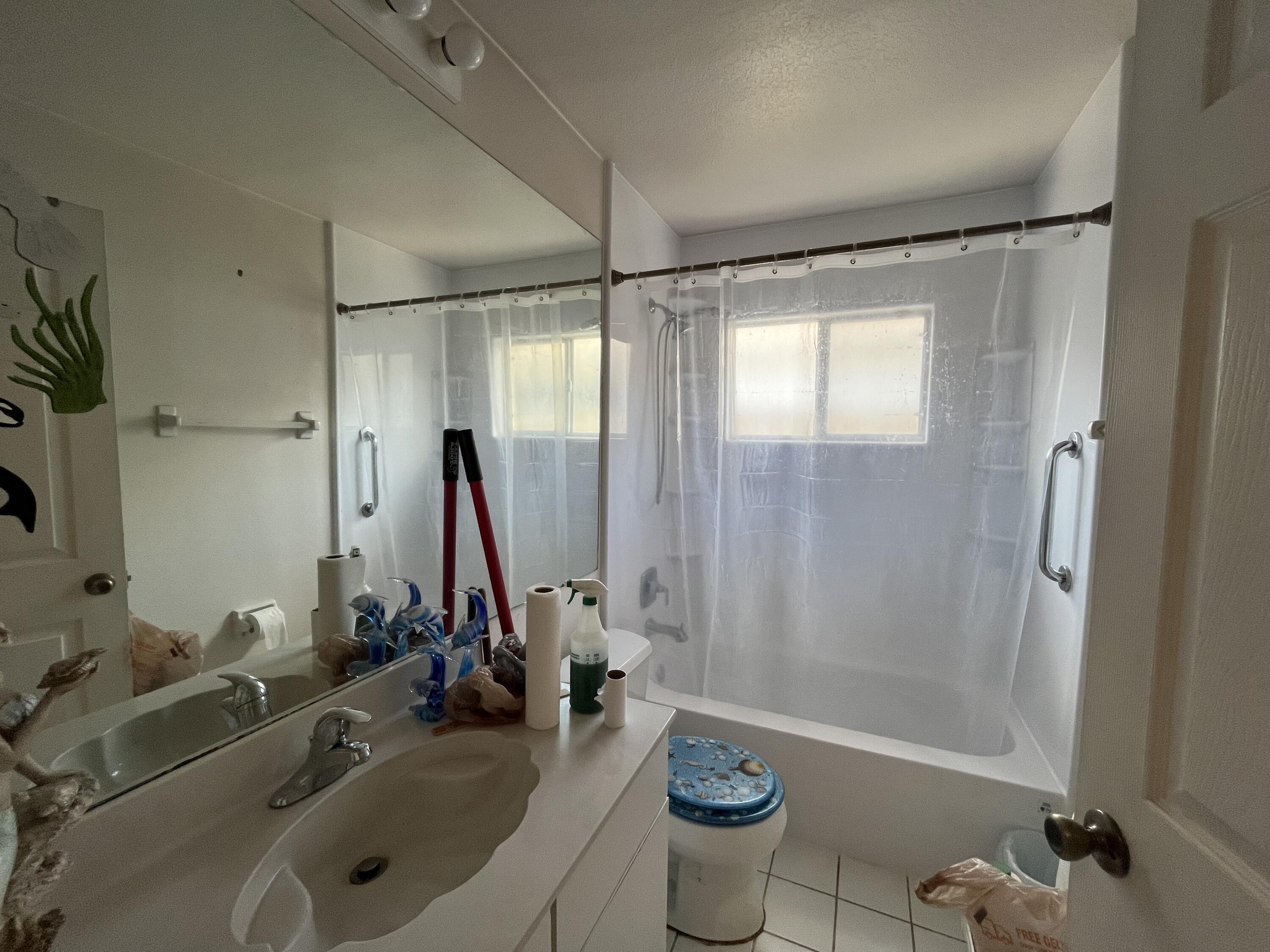 4919 Erin Lane Melbourne, FL 32940 - Photo 11 of 13 a bathroom with a tub sink toilet and mirror