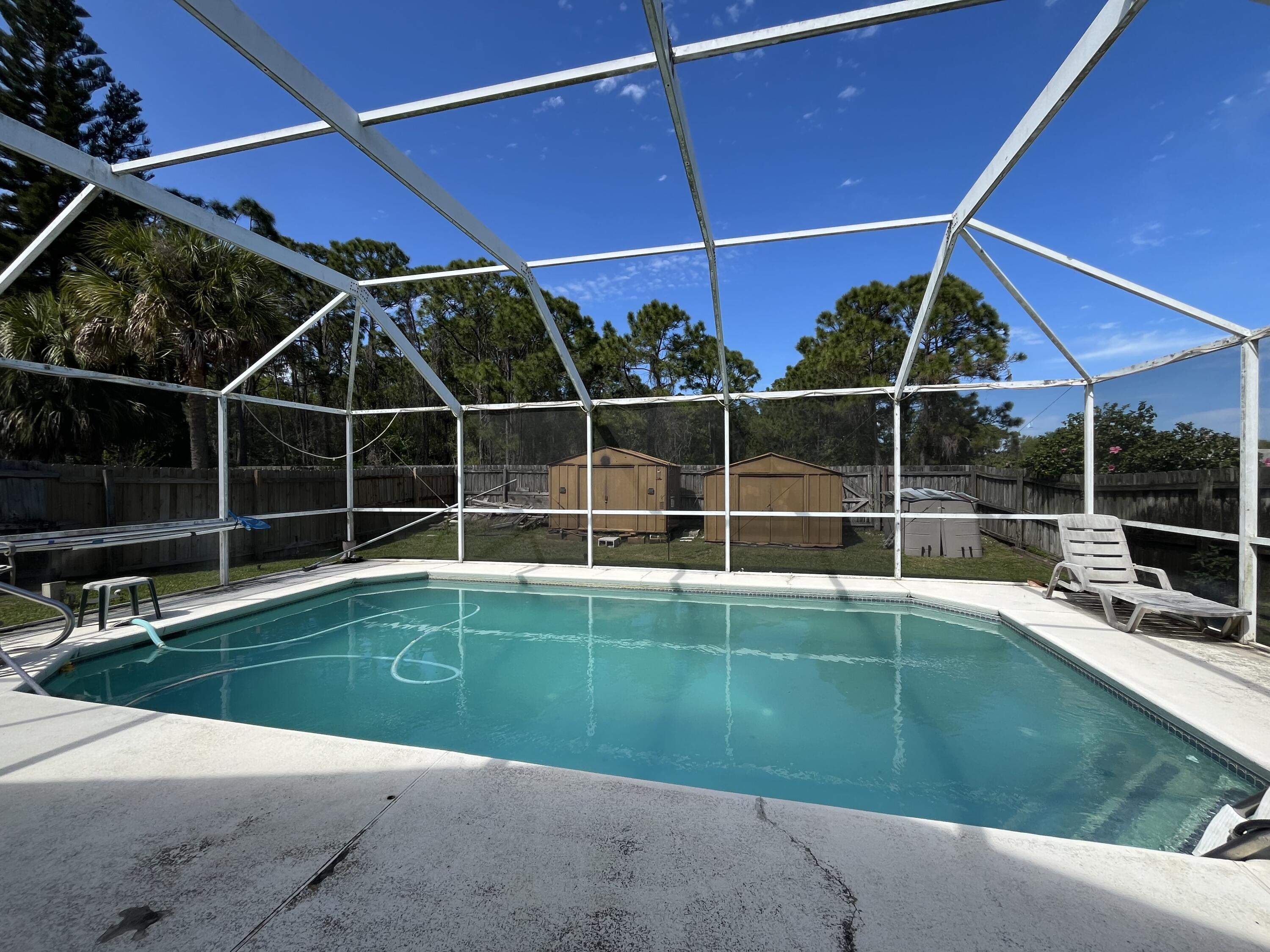 4919 Erin Lane Melbourne, FL 32940 - Photo 13 of 13 a view of a backyard with table and chairs