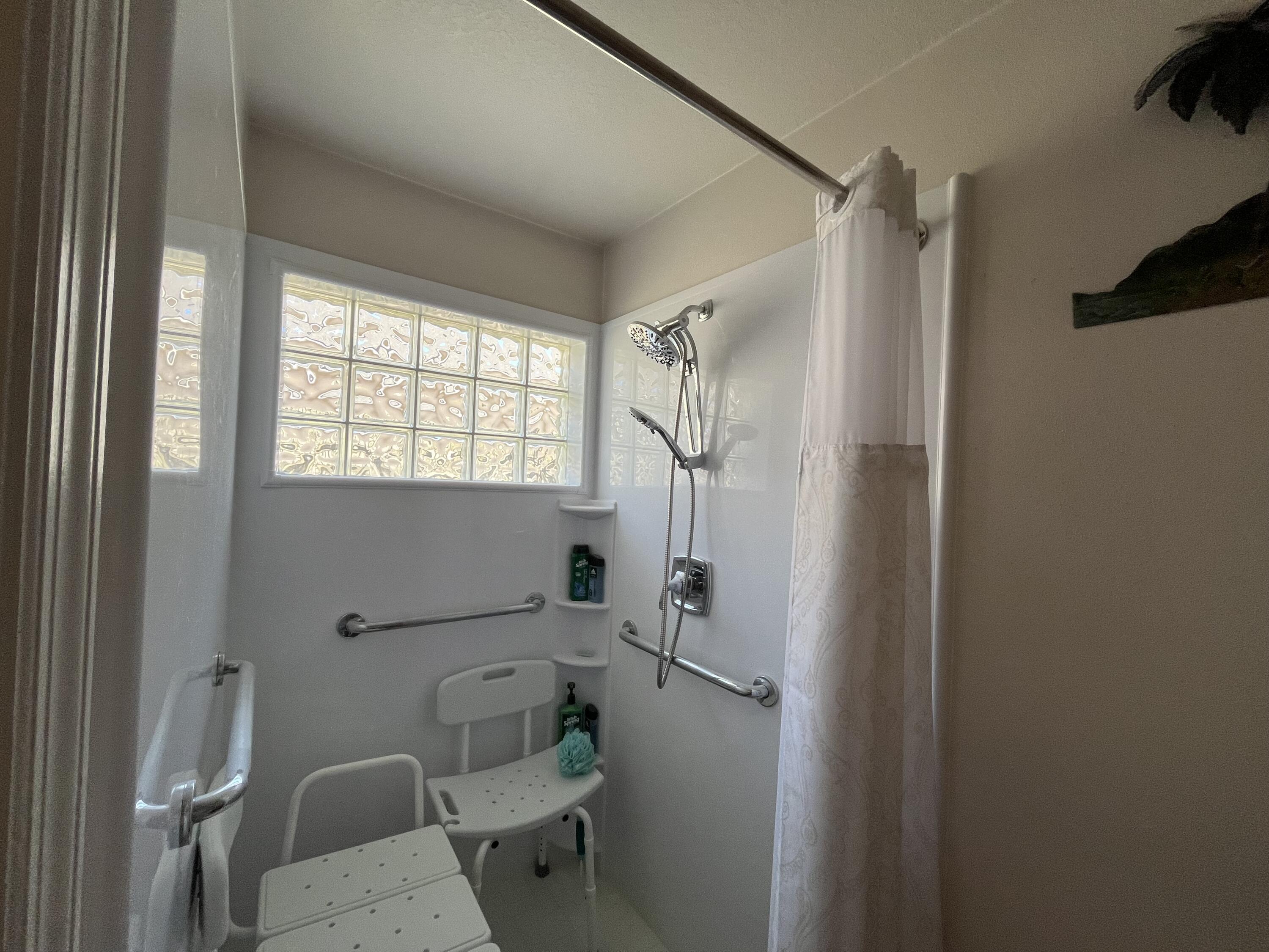 4919 Erin Lane Melbourne, FL 32940 - Photo 8 of 13 a bathroom with a toilet and a shower