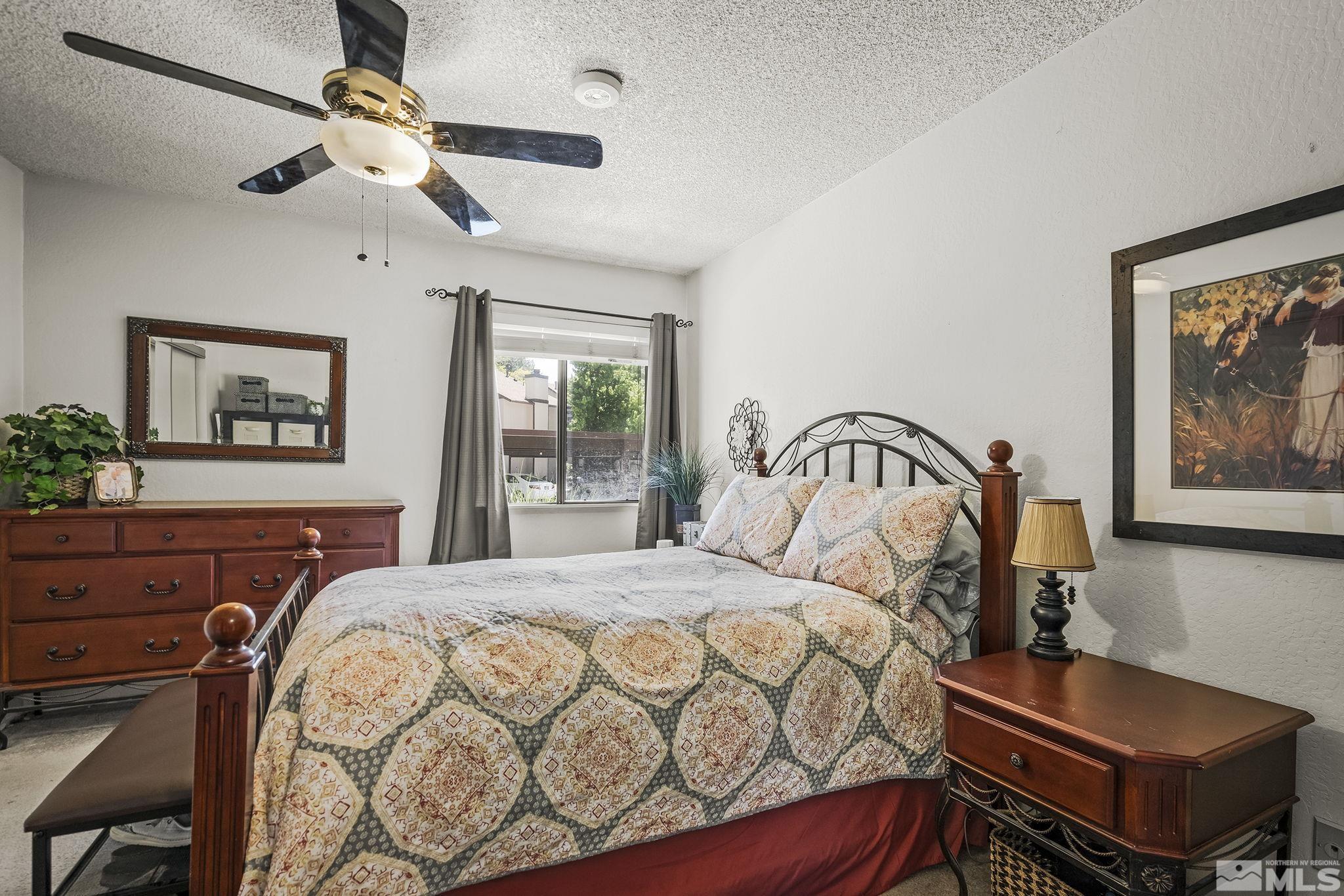 4640 Rio Poco Road Reno, NV 89502 - Photo 11 of 15 a bedroom with a bed and a dresser