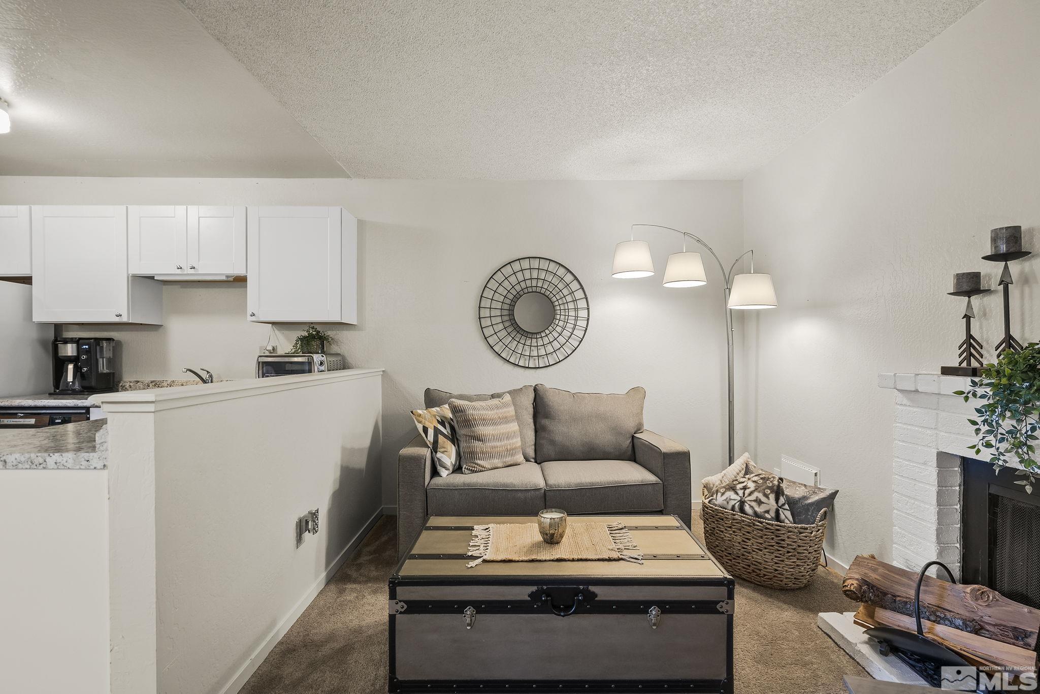 4640 Rio Poco Road Reno, NV 89502 - Photo 6 of 15 a living room with furniture a clock and a window