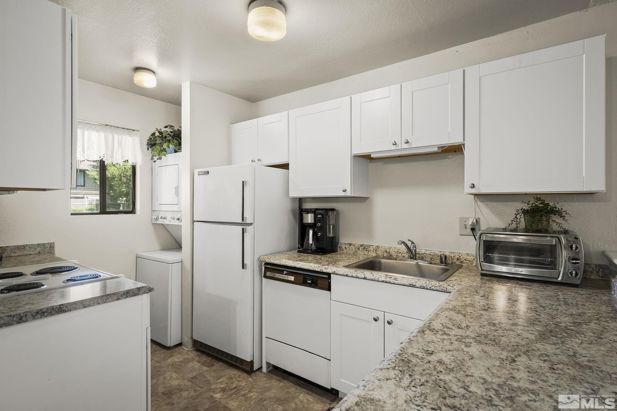 4640 Rio Poco Road Reno, NV 89502 - Photo 8 of 15 a kitchen with a refrigerator a stove a microwave and cabinets