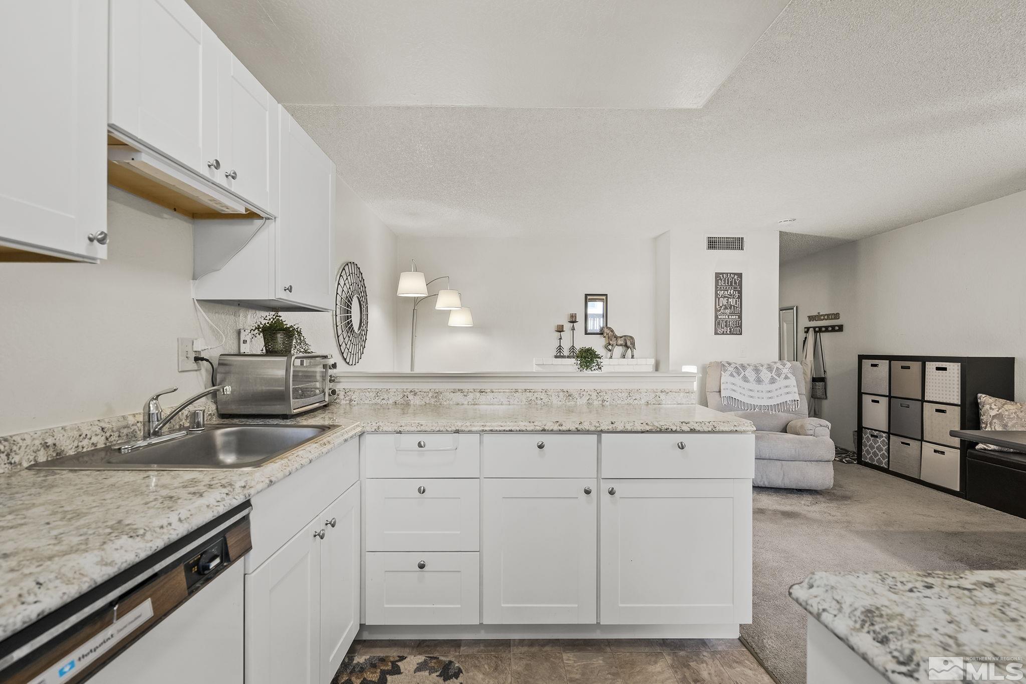 4640 Rio Poco Road Reno, NV 89502 - Photo 10 of 15 a kitchen with granite countertop a sink and cabinets