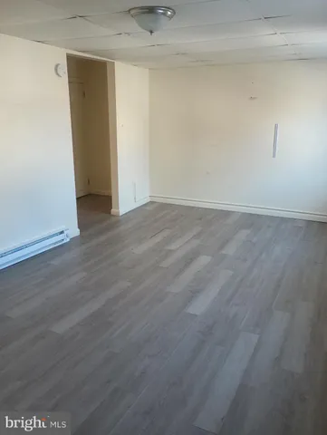 an empty room with wooden floor