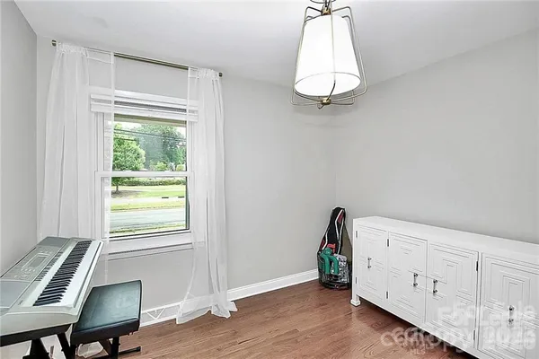 a view of a room with wooden floor cabinet and a window