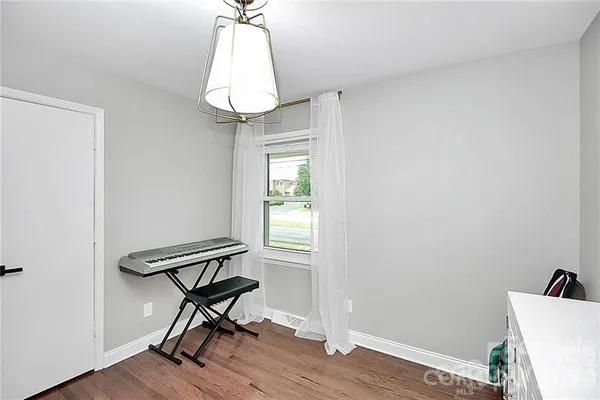 a view of a room with a hardwood and a window