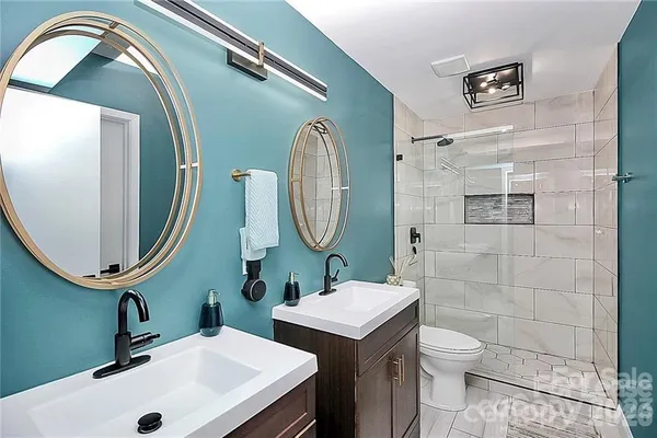 a bathroom with a toilet sink and mirror