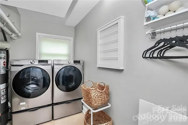 a utility room with sink dryer and washer
