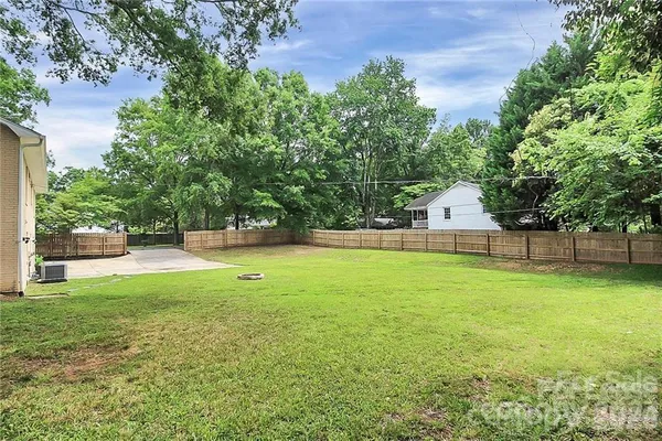 a view of a backyard with swimming pool