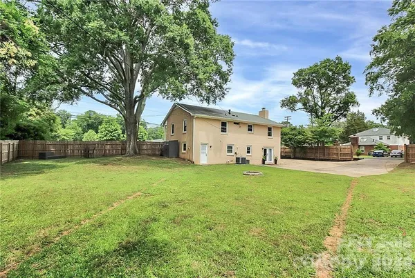 a front view of house with yard and trees