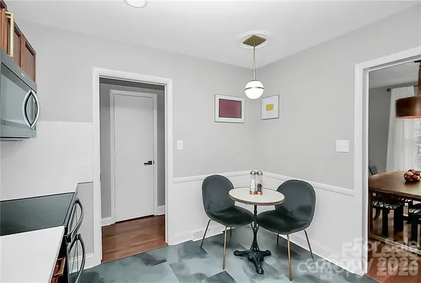 a view of a room with a table and chairs