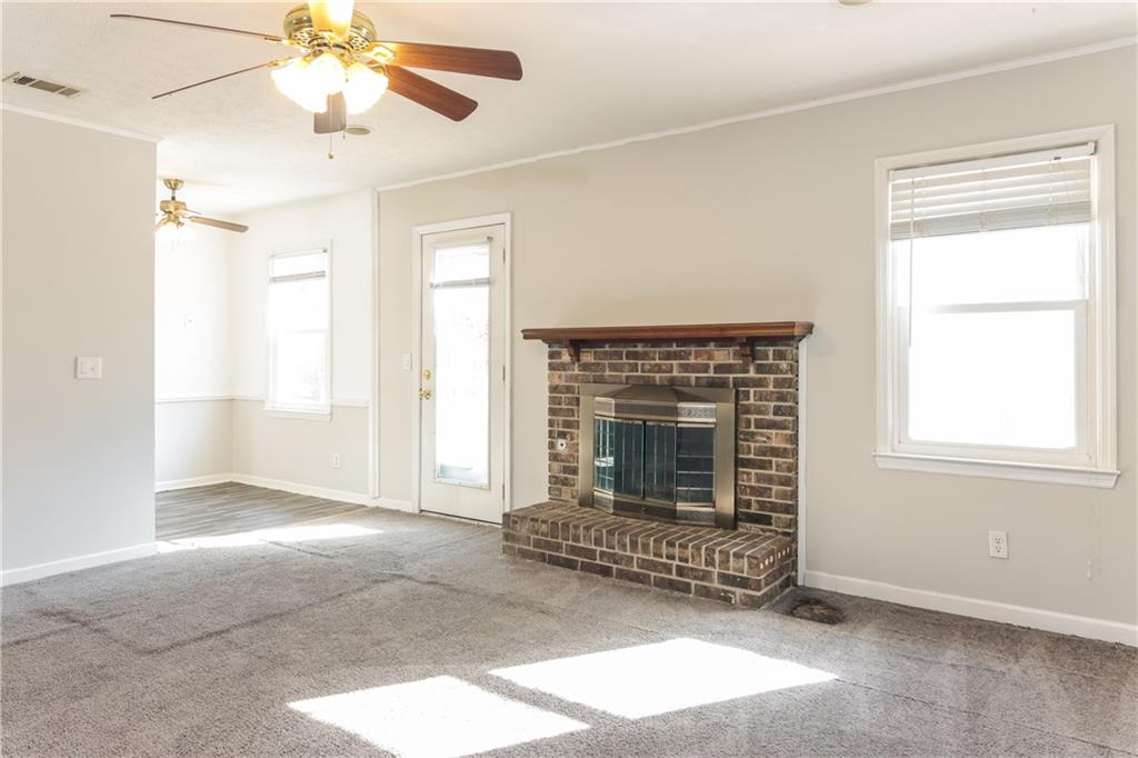 5422 Brookview Drive Columbus, GA 31907 - Photo 4 of 16 an empty room with windows and fireplace
